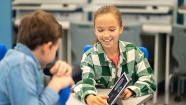 Two students are working at desks