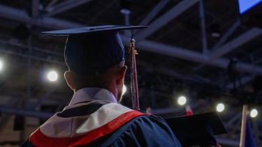 Back of the head of a graduate as they look out into the audience