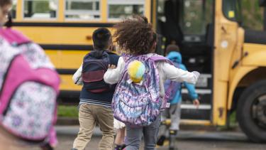 Students Running to Bus students running towards yellow school bus