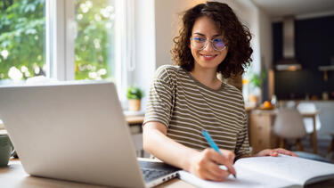 Smiling women working at a computer
