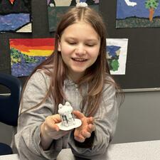 Female student showing an art piece